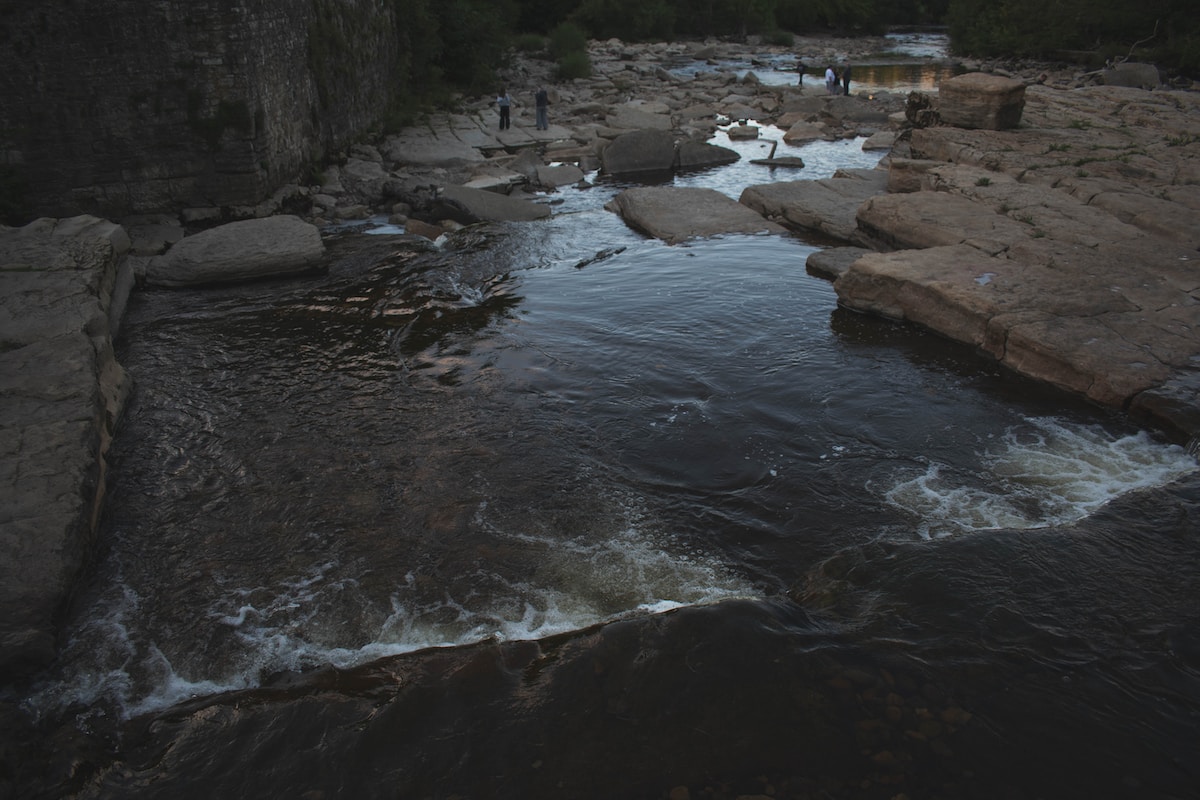 a river with rocks and people